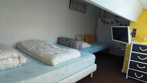 A dormitory room with two beds, a desk, and a chair. - St Cyprien: The art of seaside living (Saint-Cyprien)