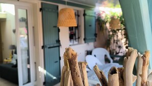 A room with a large window, a door, and a wicker lamp. - St Cyprien: The art of seaside living (Saint-Cyprien)