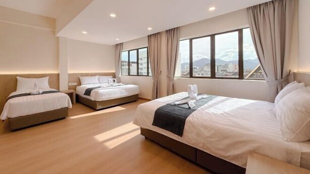 A hotel room with three beds, large windows, and a city view. - Resandau Stay Ipoh - Nearby Ipoh Town - Private Car Park and Lift - Whole Unit & Coliving (Ipoh)