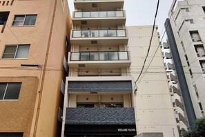 A multi-story building with a ground floor entrance, balconies on the upper floors, and a visible sign for 'REGARDE NAMB'. - Rest Collection Daikokucho Osaka (Osaka)