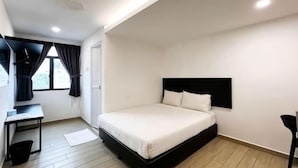 A bedroom with a bed, a desk, a chair, and a window with curtains. - E-Hotel @ Kulim (Kulim)