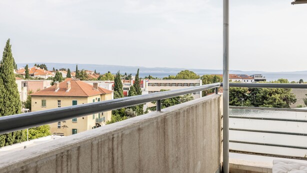 A balcony with a view of buildings and a body of water. - Le Blue, with Sea View (Split)