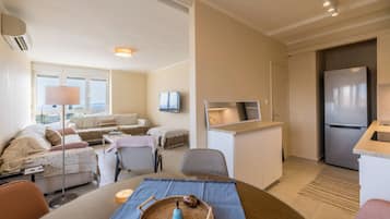 Classic Apartment, Sea View | Living area | 65-inch flat-screen TV with satellite channels