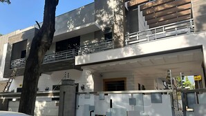 A modern two-story house with a balcony, a gated entrance, and a car parked in front. - Prime View Guest House (Islamabad)