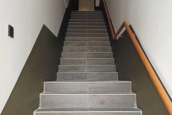 A staircase with a handrail, leading up to a landing. - Urban Sunday Jalan Langgar (langgar)