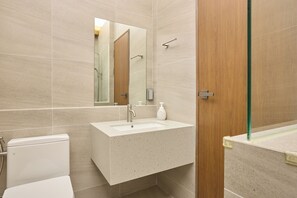 A modern bathroom with a freestanding sink, a mirror, and a toilet. - Soyeonjung (Andong)