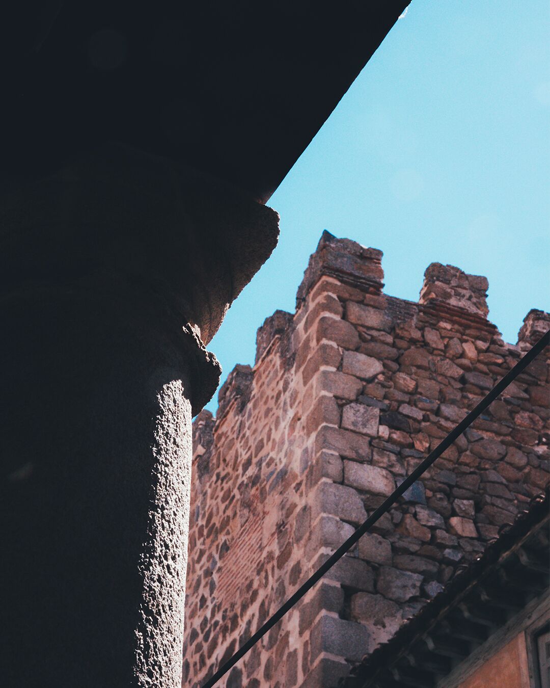 A stone building with a clear blue sky in the background.