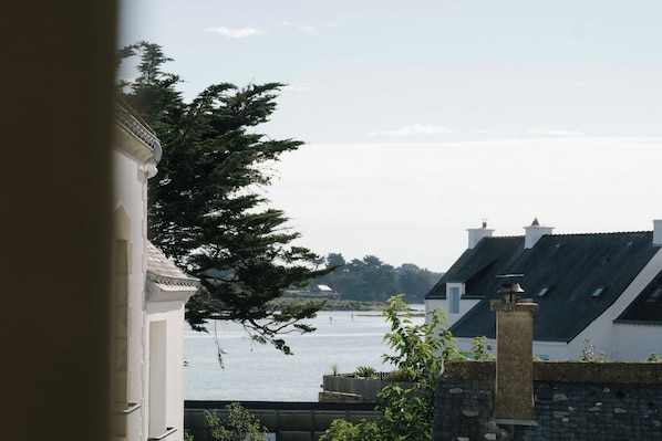 A view of a coastal area with buildings and a body of water.