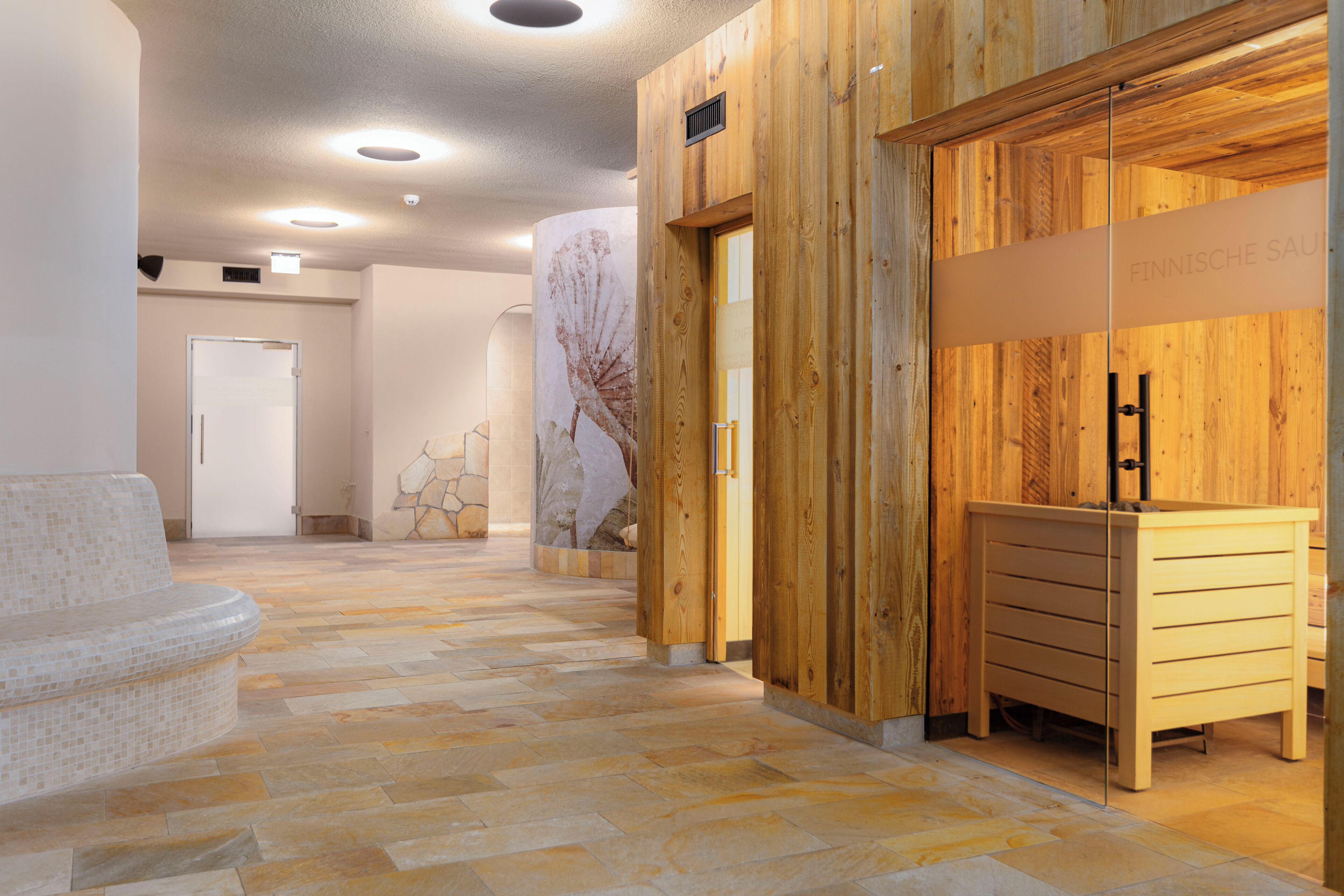 A modern interior with a wooden reception desk, a stone-tiled floor, and a minimalist design.
