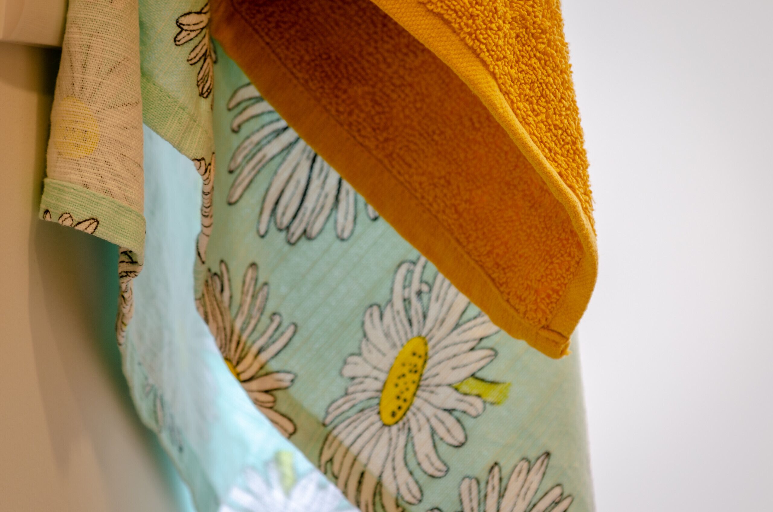 A fabric with a floral pattern and a yellow textured area.