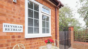 A brick building with a sign reading "Heysham Retreat".