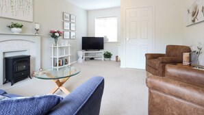A living room with a fireplace, television, and seating area.