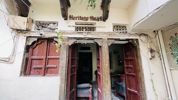A building entrance with a sign reading "Heritage Haveli". - Hotel Heritage haveli (Udaipur)