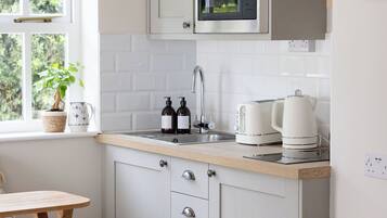 Fridge, microwave, stovetop, coffee/tea maker