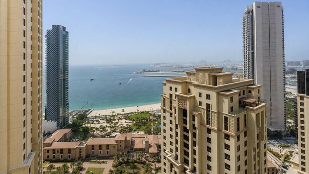 A high-rise building with a view of a beach and water. - StayShort - JBR 2 Bed Apartment sleeps 4 with Sea Views! (Jumeirah Beach Residence)