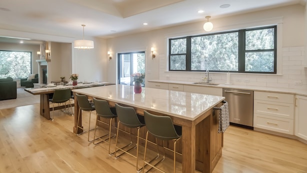 A modern kitchen with a large island, bar stools, and a dishwasher. - Ski & Hike in Kelly Canyon: Rigby Group Getaway (Rigby)