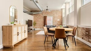 Un coin repas comprenant une table ronde, des chaises et un buffet en bois.