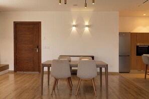 A modern kitchen with a built-in oven and a refrigerator. - Kennah Sahara | Silver Palm, New Cairo - Families Only (New Cairo)