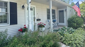 A house with a porch, a mailbox, and an American flag.