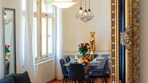 A dining area with a table, chairs, and a decorative golden cat statue.