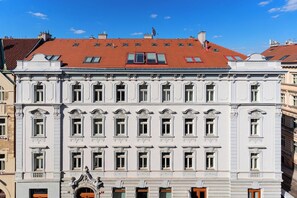 A multi-story building with a classical architectural style, featuring symmetrical windows and ornate details.