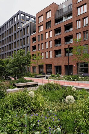 A modern building with a brick facade and multiple windows.
