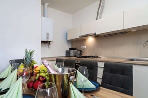 A modern kitchen with a dining area set for a meal.