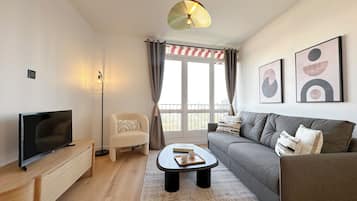 Deluxe Apartment, City View | Living area | Smart TV