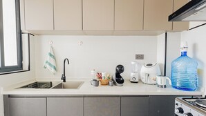 A kitchen with a sink, faucet, countertop, and a large water dispenser. - Ultimate Safari Retreat Just 9 Minutes From Jkia (Syokimau)