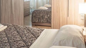 A bedroom with a bed, a wardrobe, and a mirror. - milan downtown appartment, porta venezia (Milano)