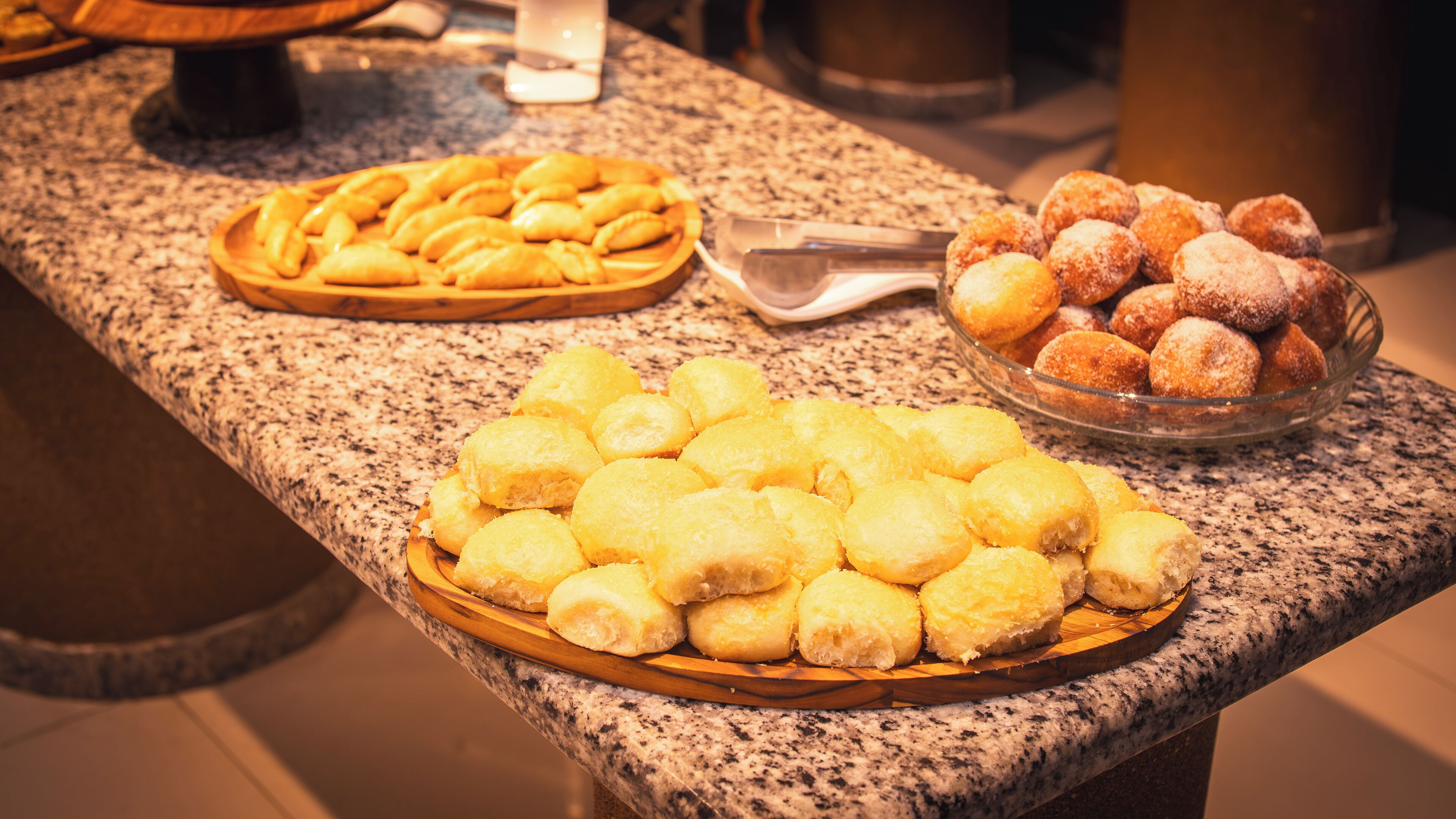 A buffet table with various pastries and desserts.