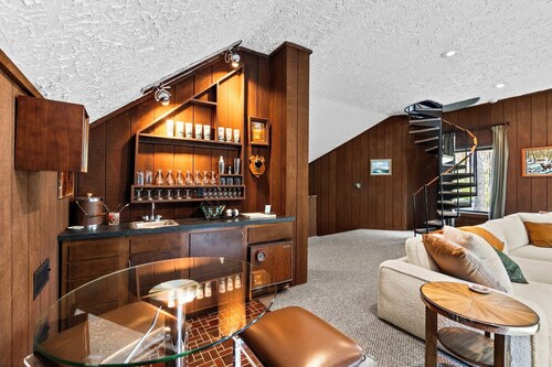 Step into Time Capsule Tower, a retro 70s escape with 5 themed bedrooms, movie room, hot tub, sauna, arcade & more. Centrally located near Northern Michigan golf, lakes, skiing, & off-road and snowmobile trails with access to a community pool.