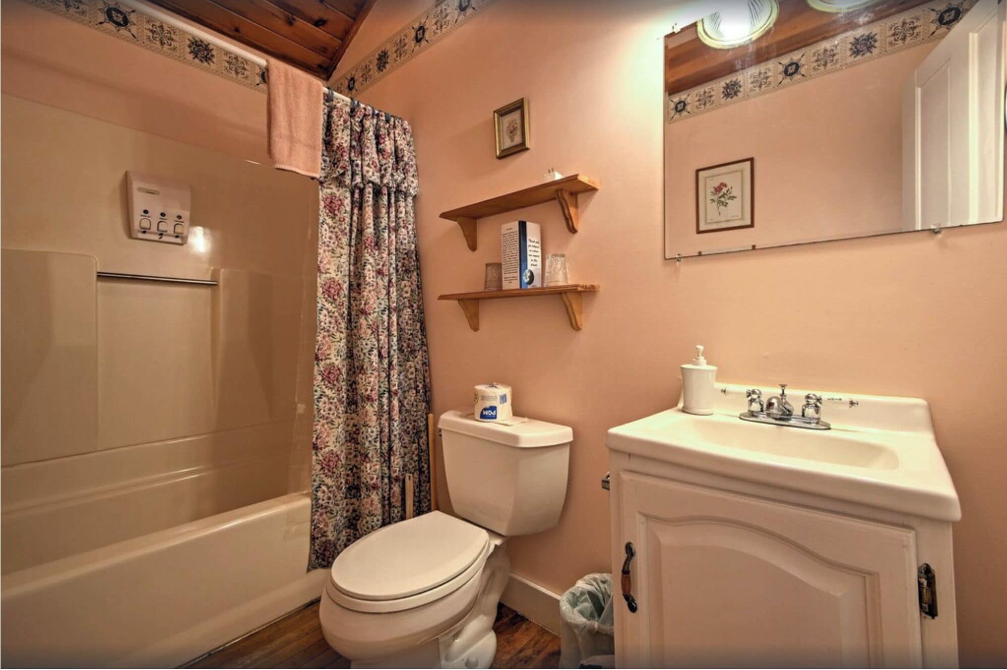 A bathroom with a bathtub, toilet, and sink.