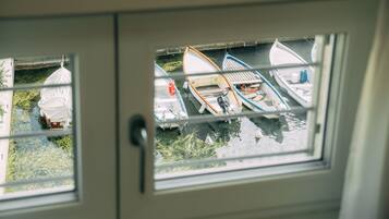 A view through a window of several boats docked at a marina.