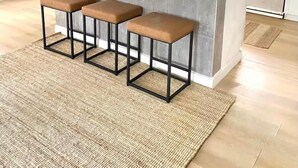 A modern kitchen with a central island, bar stools, and a view of the adjacent living area. - Pet-Friendly Estero Spacious House • Near FGCU, Beaches, RSW Airport & Hertz (Fort Myers)
