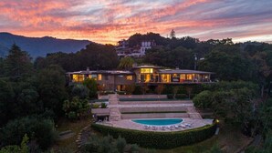 A large, modern house with a swimming pool, surrounded by lush greenery and hills in the background. - Fantastic 7-bedroom house with AC in Los Altos Hills (Los Altos Hills)