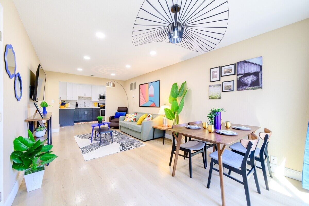 Un appartement moderne comprenant un coin repas, une cuisine et un espace de vie.