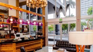 A modern interior with a wooden counter, leather seating, and large windows. - Miami Brickell Condos (Miami)