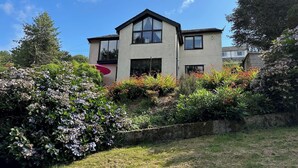 A two-story house with a garden in front. - The Rookery Sandside-Stylish Luxury Home (Kirkby in Furness)