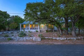A house with a porch, a front door, and a driveway. - Guadalupe Riverfront Retreat | Sleeps 10 Kerrville (Kerrville)
