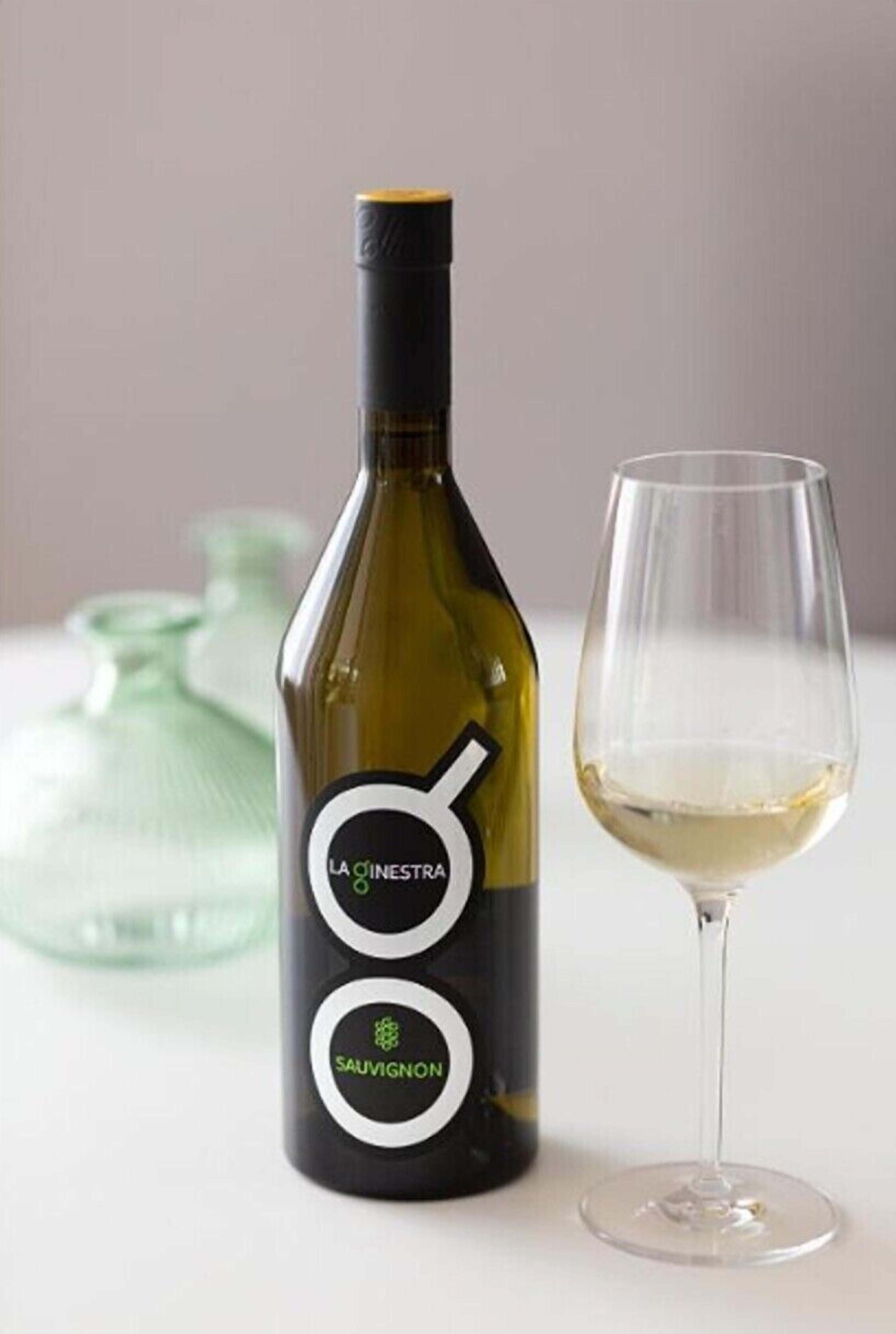 A bottle of wine with a label and a wine glass.