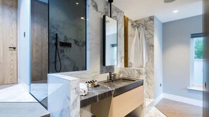 A modern bathroom with a marble sink, a large mirror, and a glass shower enclosure. - The Avicii Signature - Soho - by Frankie Says (London)