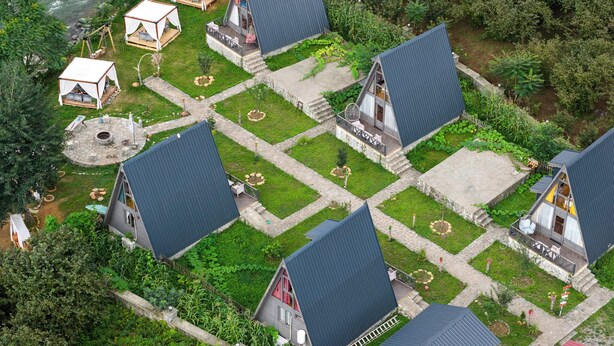 A cluster of cabins with sloped roofs, arranged in a grid pattern with a central courtyard. - Yeşil Düş Bungalov (Findikli)