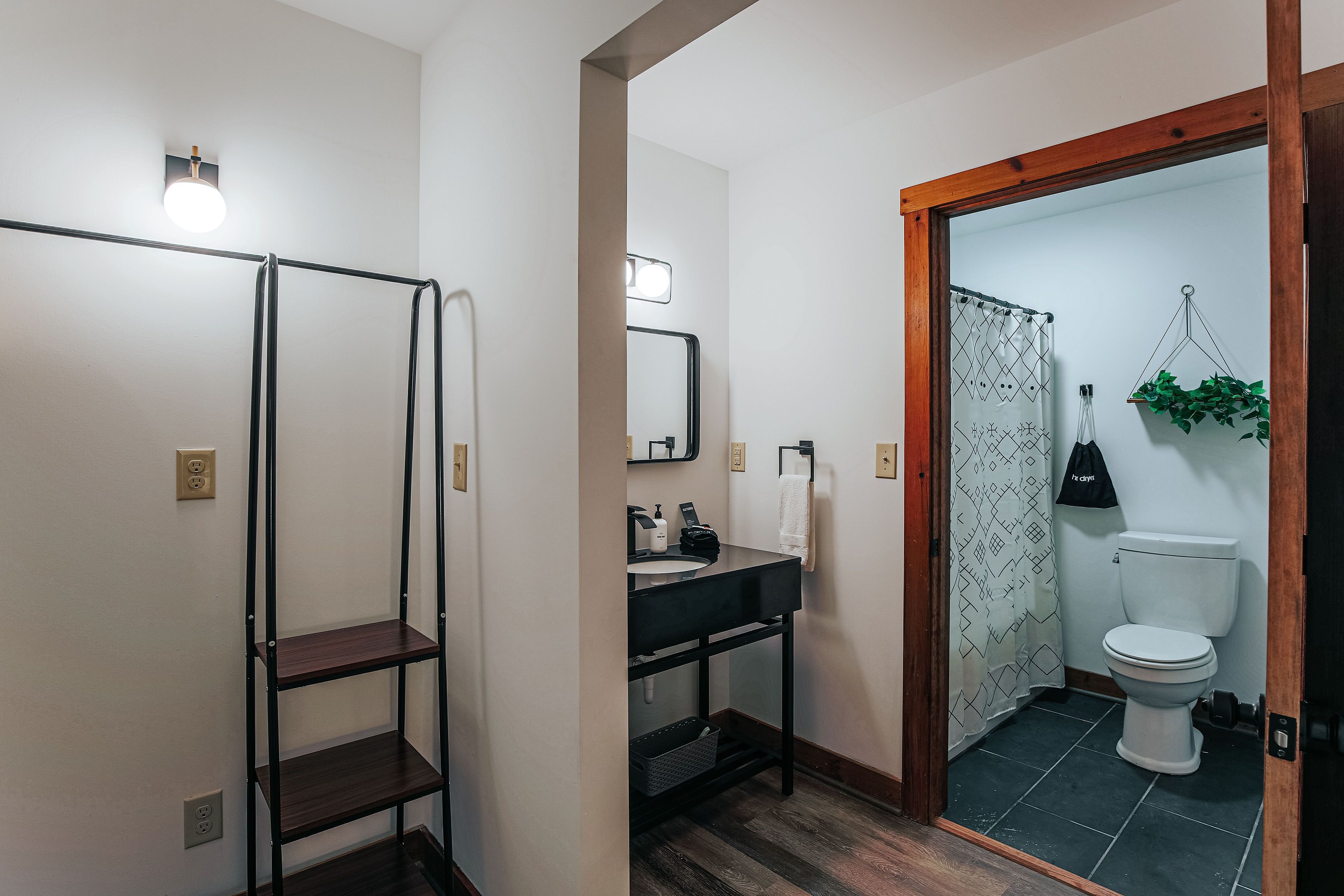 A bathroom with a shower, toilet, and sink.