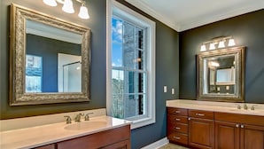A bathroom with two sinks, large mirrors, and a window. - Historic 3-Bed Townhouse w/ Courtyard & Parking (Savannah)