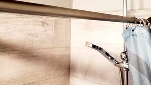 A shower area with a handheld showerhead and a fixed overhead shower. - Renaissance apartment, in the Old town of Chania (Chania)