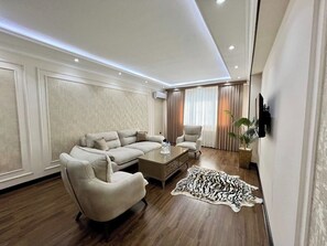 Comfort Apartment, City View | Living area | 41-inch LED TV with digital channels