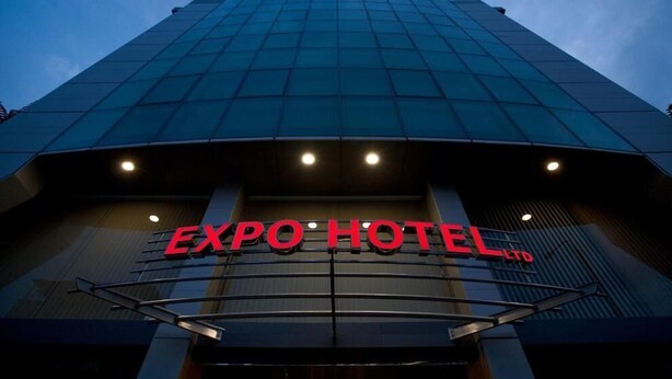 The exterior of the EXPO HOTEL LTD with a modern glass facade and illuminated signage. - Expo Hotel (Plovdiv)