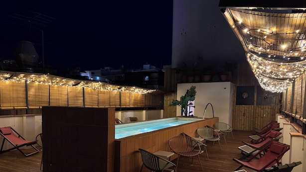 A rooftop bar with a pool, wooden deck, and lounge chairs. - BELLADORA HOTEL BOUTIQUE (Lloret de Mar)