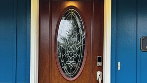 A wooden front door with a glass panel and a doorbell. - Spacious & Comfy Family Home, minutes from the Airport! (Juneau)